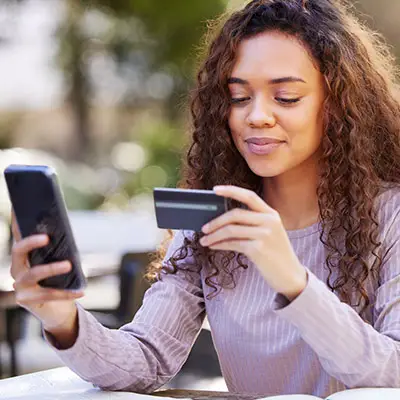 Image of college student with a credit card